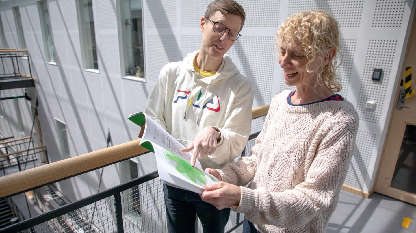 Two people examining a document